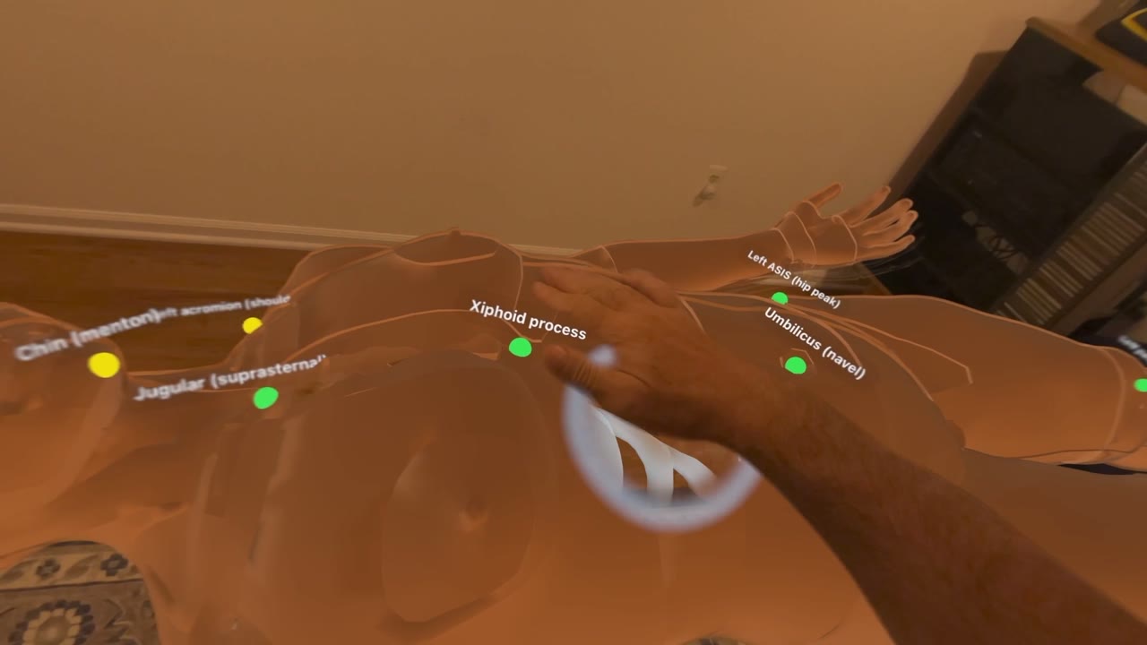 Headset view: labeled landmarks fitted to the virtual patient while a hand scanner reveals the structures beneath